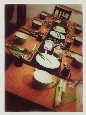 a long table with plates and utensils on it at Bed & Puppets in Rome