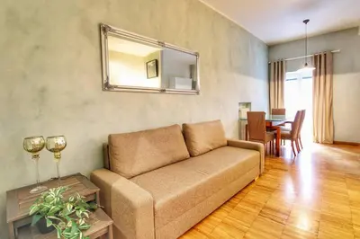 a living room with a couch and a table at Paglia45 Apartment at Trastevere by Yourhost in Rome