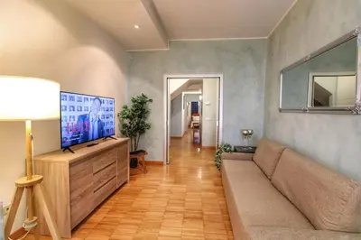 a living room with a couch and a flat screen tv at Paglia45 Apartment at Trastevere by Yourhost in Rome