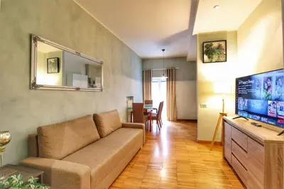 a living room with a couch and a flat screen tv at Paglia45 Apartment at Trastevere by Yourhost in Rome