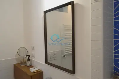 a mirror on a wall in a bathroom at Oasis of Ample Space and Comfort in Rome