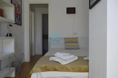 a bedroom with a bed with towels on it at Oasis of Ample Space and Comfort in Rome