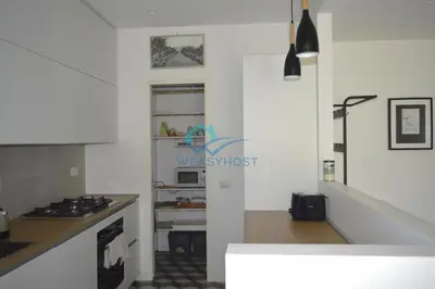 a kitchen with a stove and a refrigerator at Oasis of Ample Space and Comfort in Rome