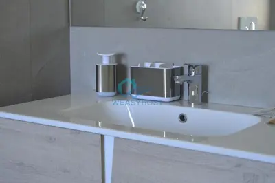 a bathroom counter with a sink and a mirror at Oasis of Ample Space and Comfort in Rome