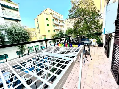 a balcony with a table and chairs on a building at Vatican home in Rome