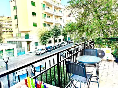 a balcony with a table and chairs and a street at Vatican home in Rome