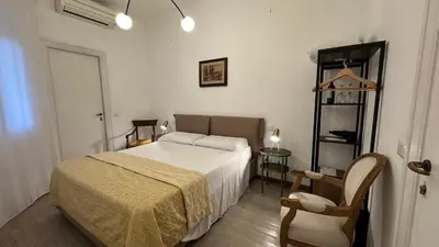 a bedroom with a bed and a chair at Presidential Vatican Palace in Rome