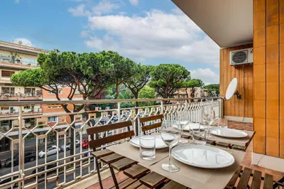 a balcony with tables and chairs and a view of a city at Presidential Vatican Palace in Rome