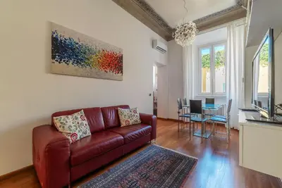 a living room with a couch and a table at GuestHost - Vittorio Emanuele Elegant Apartment in Rome