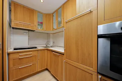 a kitchen with wooden cabinets and a stainless steel refrigerator at Vatican d'Elite in Rome