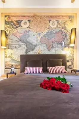 a bedroom with a large bed with red roses on it at Cristina's Home in Rome