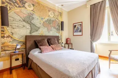 a bedroom with a bed with a map on the wall at Cristina's Home in Rome