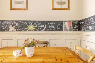 a dining room table with flowers on a chalkboard at Cristina's Home in Rome