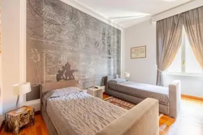 a bedroom with two beds and a couch in it at Cristina's Home in Rome