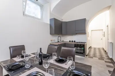a kitchen with a table with wine glasses on it at Prati 3BDR Urban Charm in Rome