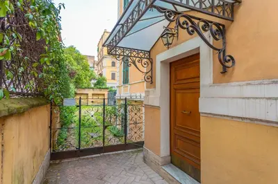 an entrance to a building with a wooden door at Prati 3BDR Urban Charm in Rome