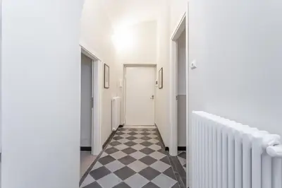 a hallway with a black and white checkered floor at Prati 3BDR Urban Charm in Rome