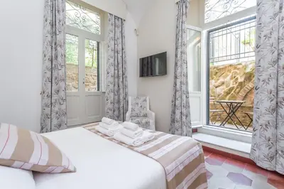 a bedroom with a bed and a large window at Prati 3BDR Urban Charm in Rome