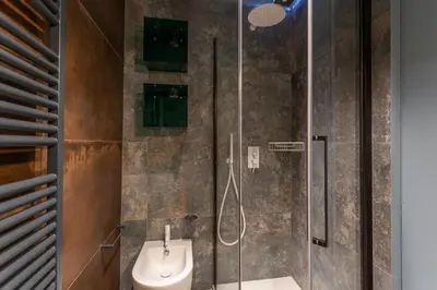 a bathroom with a shower with a toilet and a sink at Eclectica Living by Navona Square in Rome