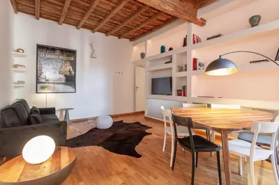 a kitchen and living room with a wooden table and chairs at Eclectica Living by Navona Square in Rome