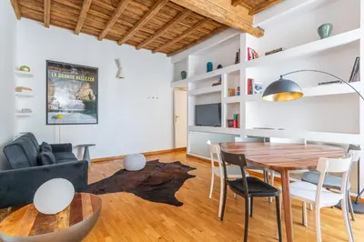 a kitchen and living room with a wooden table and chairs at Eclectica Living by Navona Square in Rome
