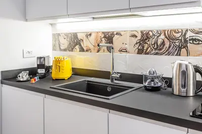 a kitchen counter with a sink in a kitchen at Eclectica Living by Navona Square in Rome