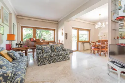 a living room with two couches and a dining room at St Peters Garden 3 BDR Apartment in Rome