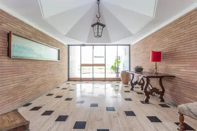 a living room with a table and a large window at St Peters Garden 3 BDR Apartment in Rome