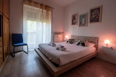 a bedroom with a large bed with three dogs on it at La casa a Cornelia in Rome