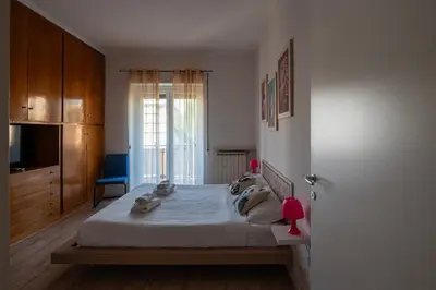 a bedroom with a large bed and a window at La casa a Cornelia in Rome