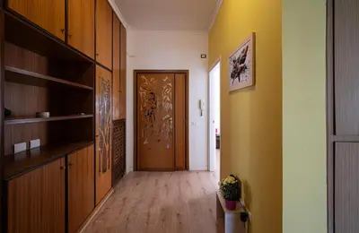 a hallway with a wooden door in a room at La casa a Cornelia in Rome