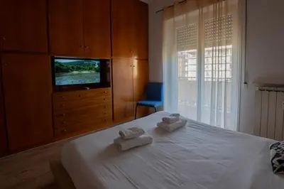 a bedroom with a bed with two towels on it at La casa a Cornelia in Rome