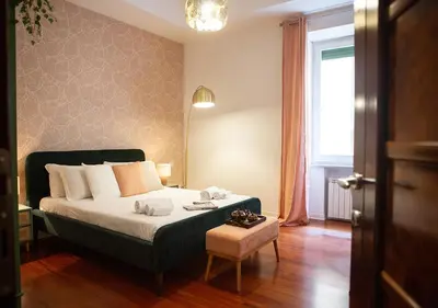 a bedroom with a large bed and a window at Termini Alever apartament 3 bedrooms in Rome