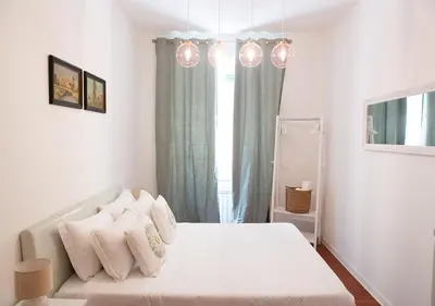 a white bedroom with a bed and a window at Termini Alever apartament 3 bedrooms in Rome