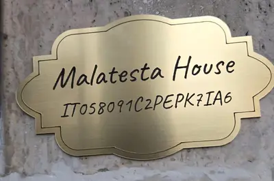 a sign for a malisterosa house toscaccoaccozona at Malatesta House in Rome