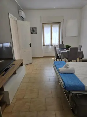 a living room with a table and a dining room at Malatesta House in Rome