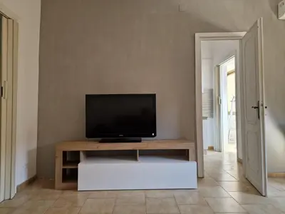 a living room with a television on a table at Malatesta House in Rome