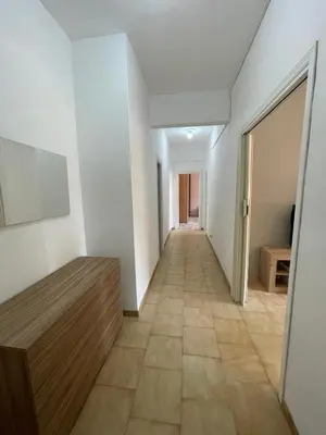 a hallway of a room with white walls and a tile floor at Malatesta House in Rome
