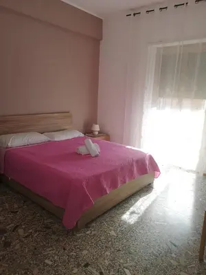 a bedroom with a bed with a pink blanket at Malatesta House in Rome