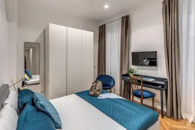 a hotel room with a bed and a desk at Margana Apartment - Maison D'art Collection in Rome