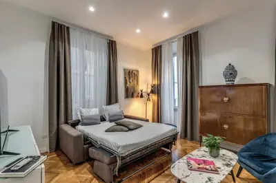 a bedroom with a bed and a living room at Margana Apartment - Maison D'art Collection in Rome