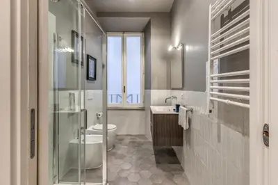 a bathroom with a toilet and a sink at Margana Apartment - Maison D'art Collection in Rome