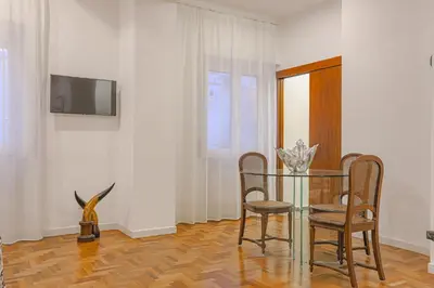 a dining room with a glass table and chairs at Piazza Navona Deluxe Apartment - Piano 2 Roma in Rome