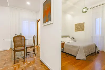 a bedroom with a bed and a table and chairs at Piazza Navona Deluxe Apartment - Piano 2 Roma in Rome