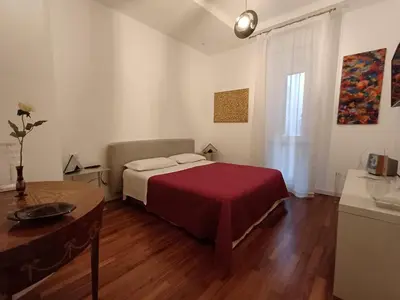 a bedroom with a bed and a table in it at Piazza Navona Deluxe Apartment - Piano 2 Roma in Rome