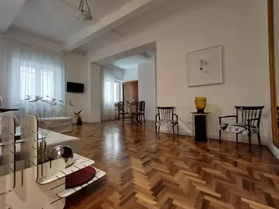 a living room with a wooden floor and chairs at Piazza Navona Deluxe Apartment - Piano 2 Roma in Rome