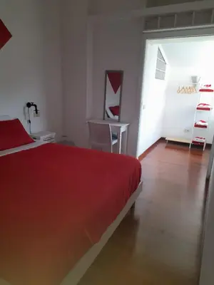 a bedroom with a bed and a table and a desk at Casa Miso in Rome