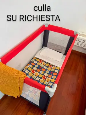 a red and white bed in a room at Casa Miso in Rome