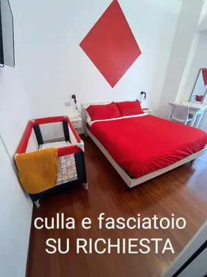 a bedroom with a red bed with a red blanket at Casa Miso in Rome