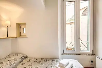 a white room with a bed and a window at Navona flat in Rome